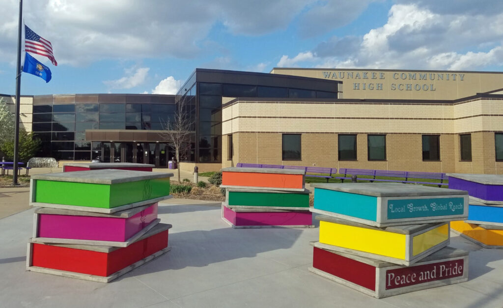 Large book sculpture in front of Waunakee Community High School.